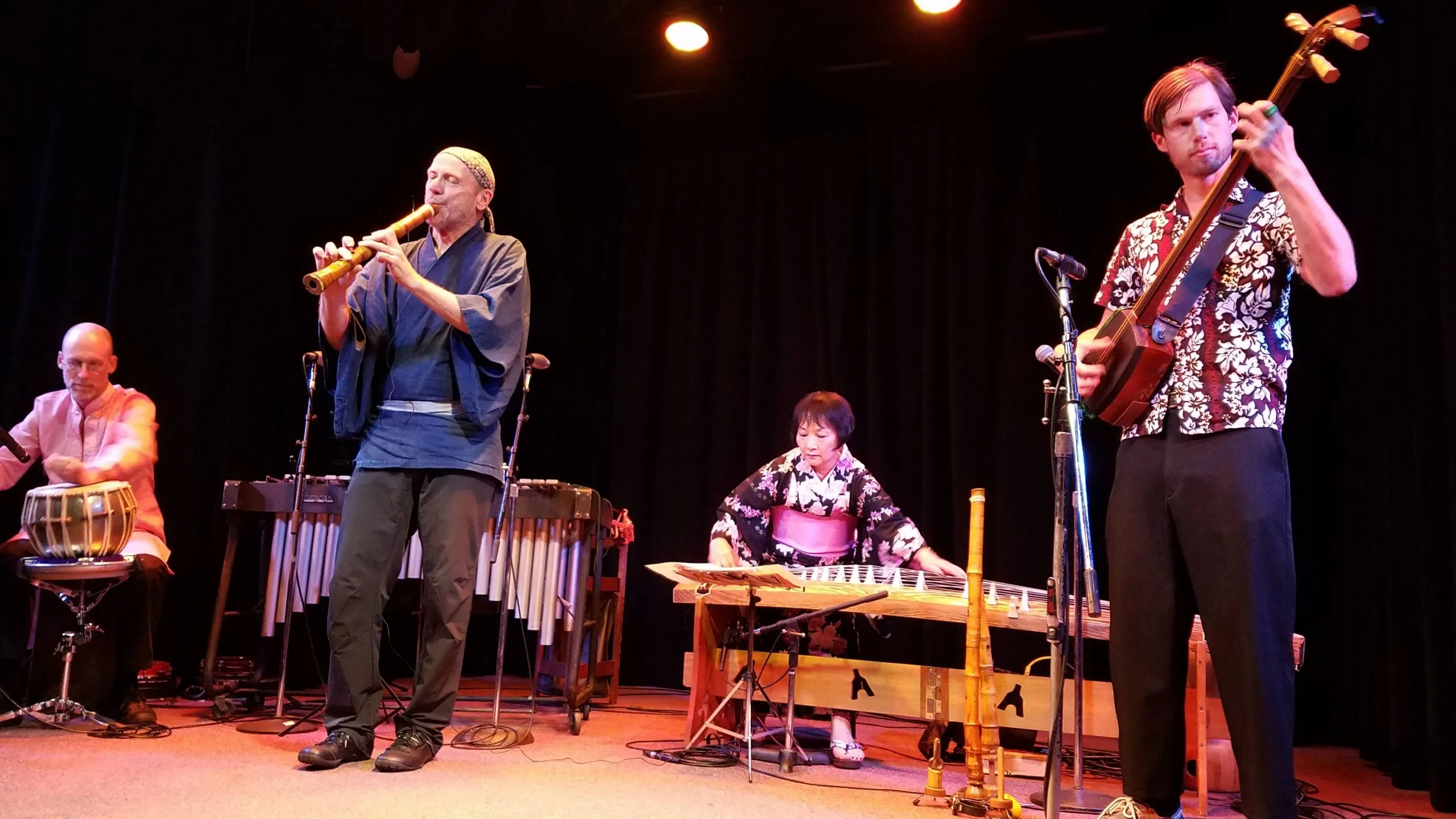 Kyle performing with a world-fusion ensemble of flute, percussion, and koto